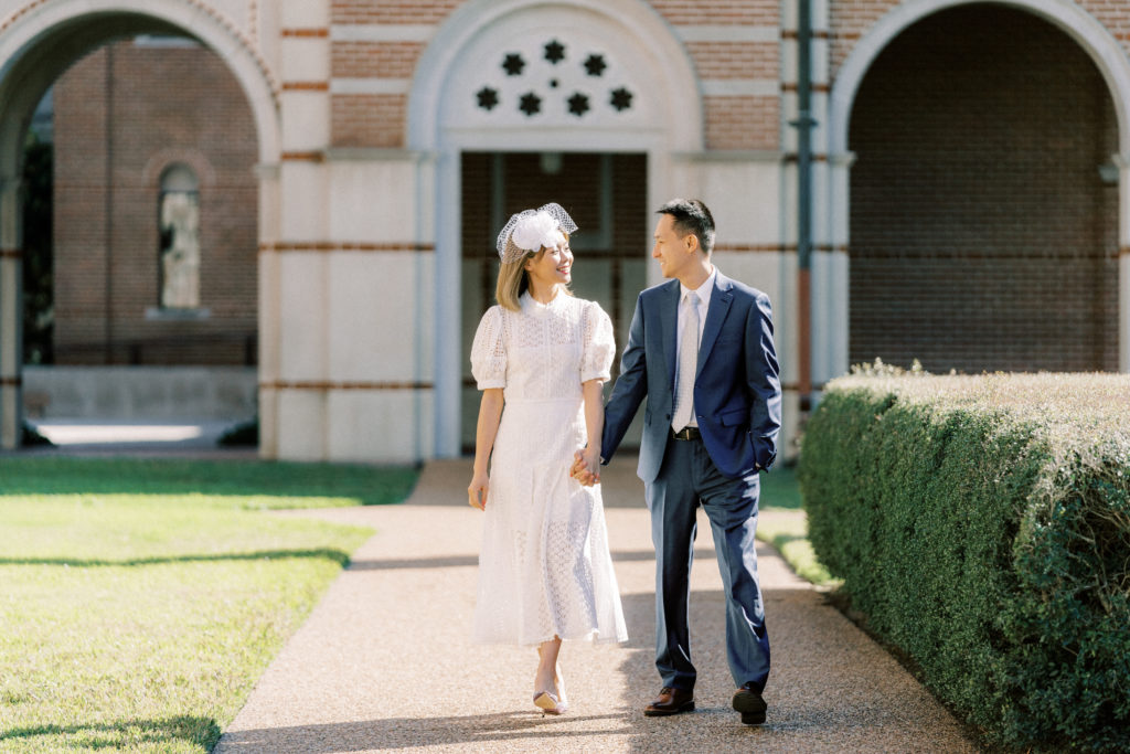 bride and groom walking through rive university